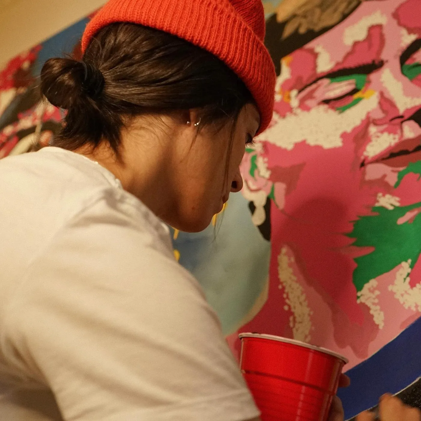 Grethekell painting a mural, mid-brushstroke